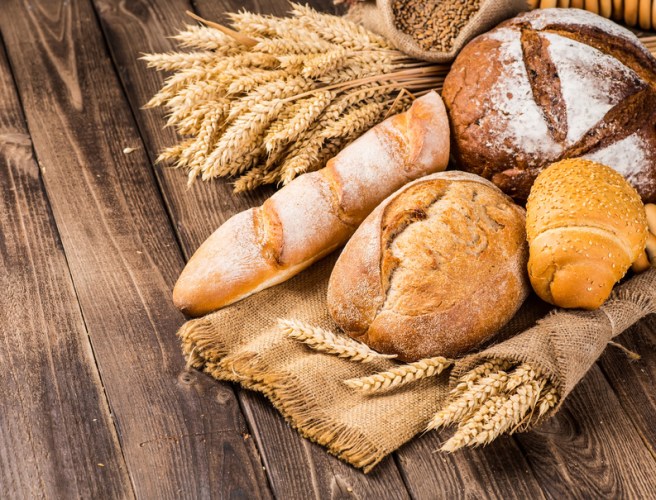 assortment of baked bread on wood table
